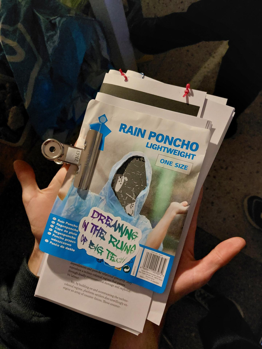 A contingency reader, including a rain poncho and some stickers held in the palm of a strikers hand