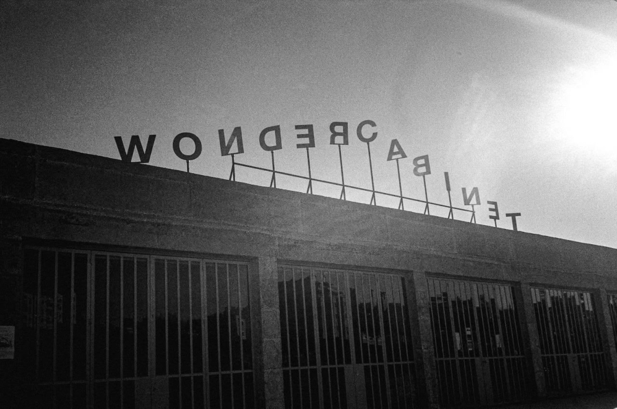 Stylized photo of the the steel letters spelling "Wonder Cabinet" on top of the building of the space.